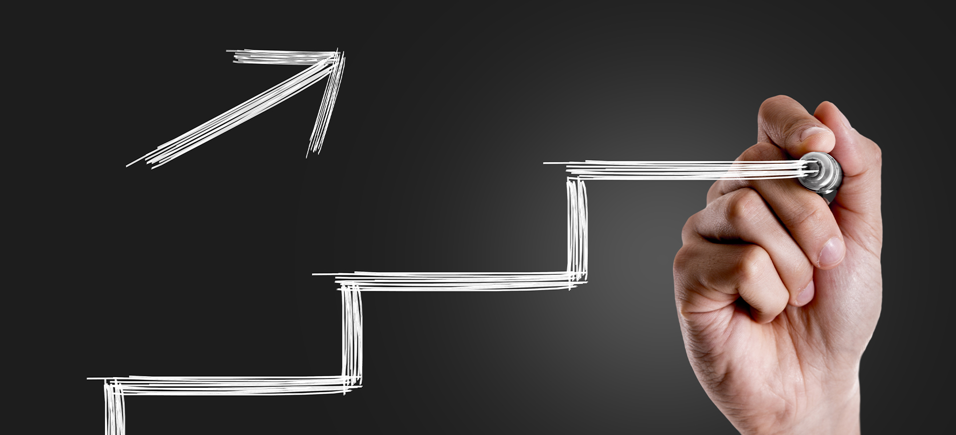 A hand with a marker draws a stair-step line along with a diagonal arrow pointing up in white writing on a dark gray gradient background.